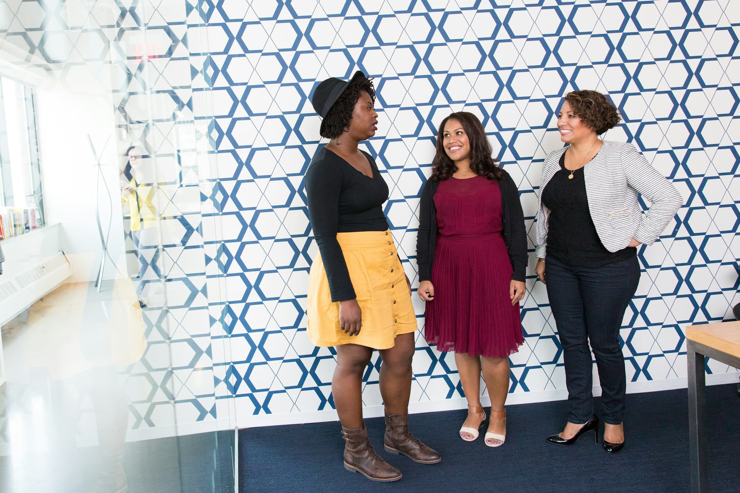 Team members chatting in a bright, modern innovation hub