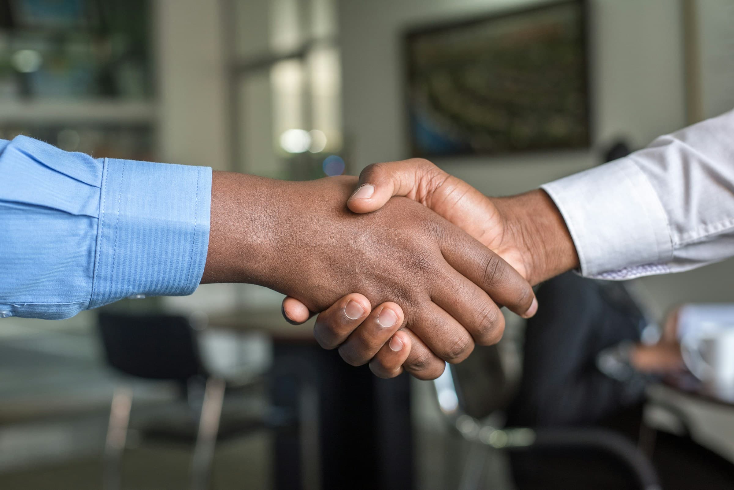 A handshake between an investor and a founder, sealing a partnership
